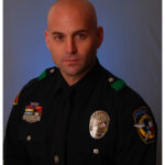 Formal studio portrait of a uniformed law enforcement professional symbolizing the leadership and expertise behind ChrisGrollnek.com and its mission in active shooter prevention and community safety.